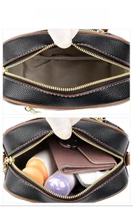Interior view of black pebble leather crossbody bag showing main pocket and daily essentials
