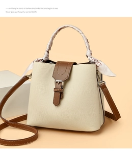 Macro detail of cream bucket bag with lychee texture and floral silk scarf handle