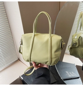Close-up of avocado green litchi grain tote bag with detachable strap and top handle