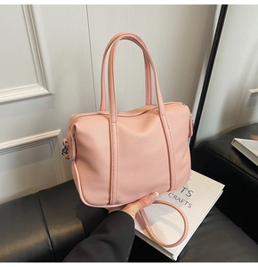 Pink lychee texture handbag with dual top handles and detachable crossbody strap