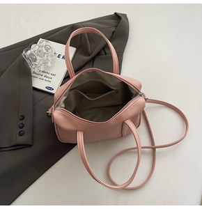 Detailed view of pink lychee leather handbag interior with a practical zipper pocket