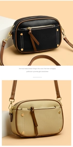 Macro detail of lychee grain leather camera bag with contrast piping and gold hardware