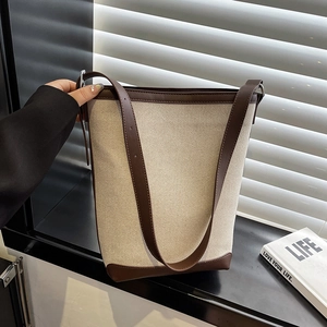 Minimalist bucket tote bag in beige canvas and brown leather trim with double straps