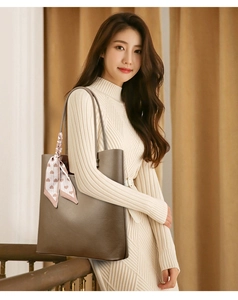 Fashionable dark brown leather tote bag with a pink heart silk scarf on the shoulder strap