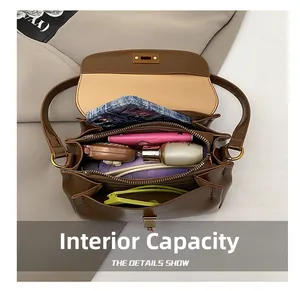 Top view of deep brown leather crossbody bag showing spacious interior compartments with items