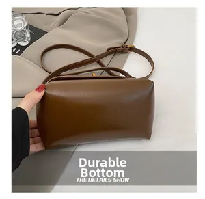 Detail showing the wear-resistant bottom of the vintage brown square crossbody bag