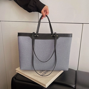 Large striped canvas tote bag with black leather trim and white stitching details
