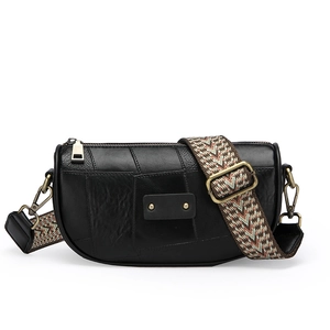 Retro black leather half-moon crossbody bag with vintage bronze hardware and patterned strap