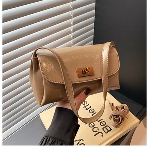 Detail of khaki PU leather crossbody bag with golden rectangular twist-lock and glossy finish