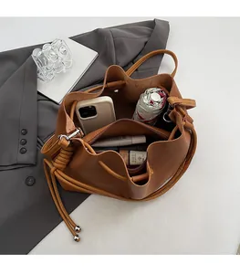Interior view of brown bucket bag showing multi-layer storage and spacious capacity