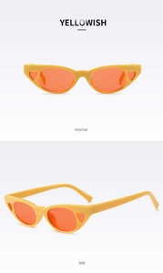 Detail view of cat eye sunglasses with heart cut-outs in vibrant yellowish orange finish