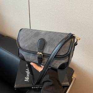 Retro denim texture crossbody bag with black leather trim and gold buckle details