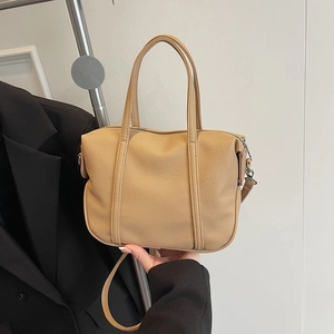 Brown litchi grain leather tote bag with dual handles and adjustable shoulder strap