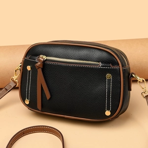 Chic black litchi leather crossbody bag with brown trim and gold hardware accents