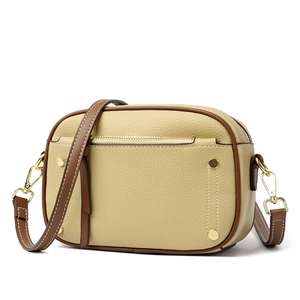 Minimalist beige and brown colorblock crossbody bag with pebbled leather and gold hardware
