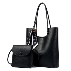 Black pebbled leather tote bag with small crossbody flap bag and heart pattern scarf