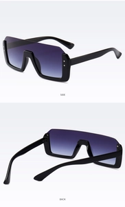 Detailansicht der Oversize-Schild-Sonnenbrille mit schwarzem Rahmen und lila Farbverlauf