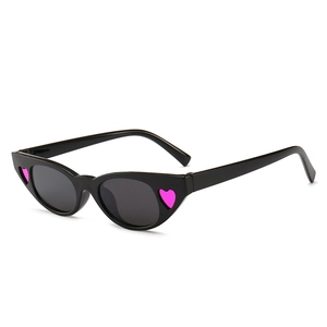 Fashionable black cat-eye sunglasses with pink heart accents on a white background