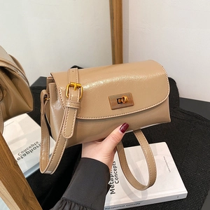 Retro brown flap crossbody bag with glossy texture and gold rectangular twist lock