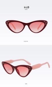 Dettaglio occhiali da sole rossi cat eye con strass e lenti rosa sfumate