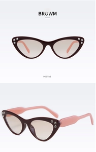 Dettaglio degli occhiali da sole cat-eye con strass e lenti marroni sfumate