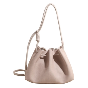 Minimalist beige bucket bag with lychee pattern leather and drawstring closure