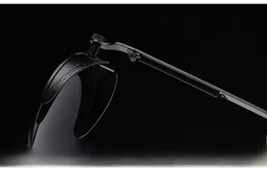 Close-up of reinforced metal hinges and spring temples on black steampunk sunglasses