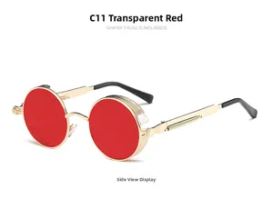 Detail of steampunk round sunglasses with gold metal frame and red transparent lenses