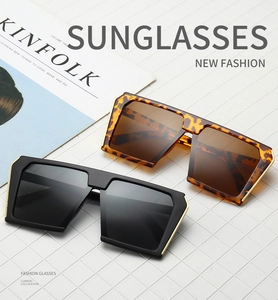 Detail of square oversized sunglasses with gold metal trim and stylish tortoiseshell frames