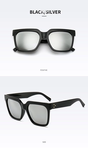 Detail view of black square oversized sunglasses with silver reflective mirrored lenses