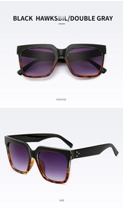 Detail of square sunglasses with black and tortoiseshell frame and gradient lenses