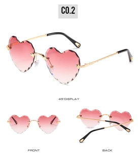 Frameless heart-shaped sunglasses with pink gradient lenses and gold metallic frame details