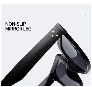 Detail of non-slip temple on black square sunglasses with golden rivet accents