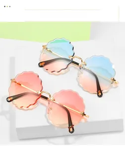 Detail of rimless sunglasses featuring flower-edged wave lenses in ocean gradient tints