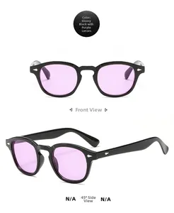 Close-up of retro black frame sunglasses with purple lenses and silver rivets