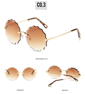 Three-view display of rimless flower-cut sunglasses with brown gradient lenses and gold temples