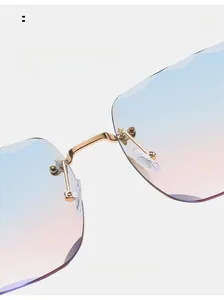 Detail of rimless square sunglasses featuring gold metal bridge and soft silicone nose pads