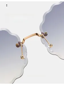 Detail of purple gradient cloud-shaped lenses and golden metal nose pads on rimless glasses