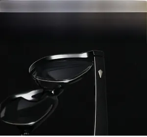 Detail of glossy black eyewear temples with silver diamond accents in vintage style