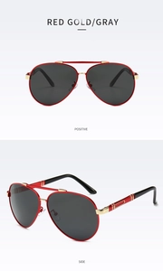 Detail of red gold aviator sunglasses featuring grey polarized lenses and metal frame