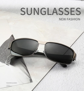 Detailed shot of classic rectangular polarized sunglasses on a textured stone background