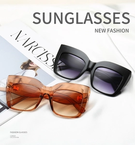 Fashionable oversized square sunglasses with gradient lenses on white silk background