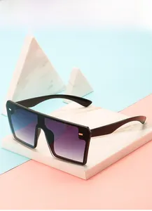 Detail view of black oversized square sunglasses with purple gradient lenses and wide temples