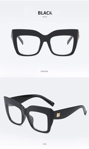 Detail of black oversized square sunglasses with gold metal decoration on temple