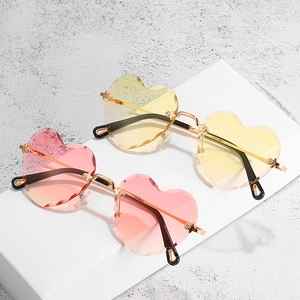 Frameless heart-shaped sunglasses with gradient pink and yellow lenses in metal frame