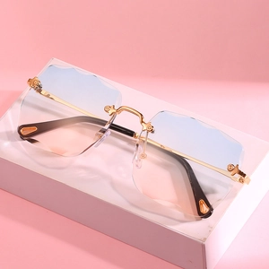 Rimless square sunglasses with blue-pink gradient lenses and gold engraved metal frame
