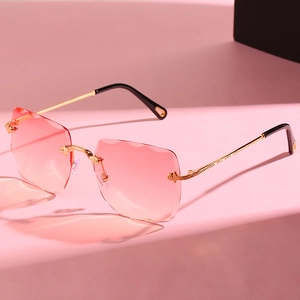 Frameless square sunglasses for women with pink gradient lenses and gold carved metal temples