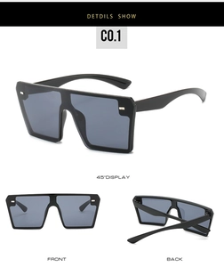 Detail view of black rimless square sunglasses with silver rivets and flat top design