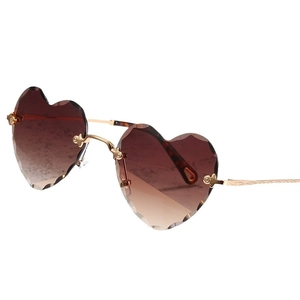 Rimless heart shaped sunglasses with gradient brown lenses and scalloped gold metal frame
