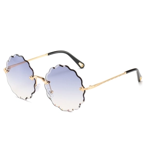 Frameless women's sunglasses with scalloped gradient lenses and carved metal temples